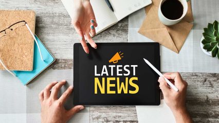 A tablet with the words "Latest News"
