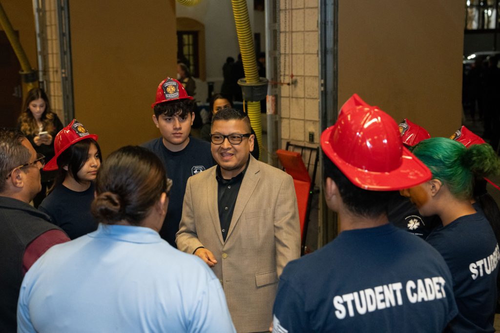 Jesse Armendarez talking to a group of junior fire fighters