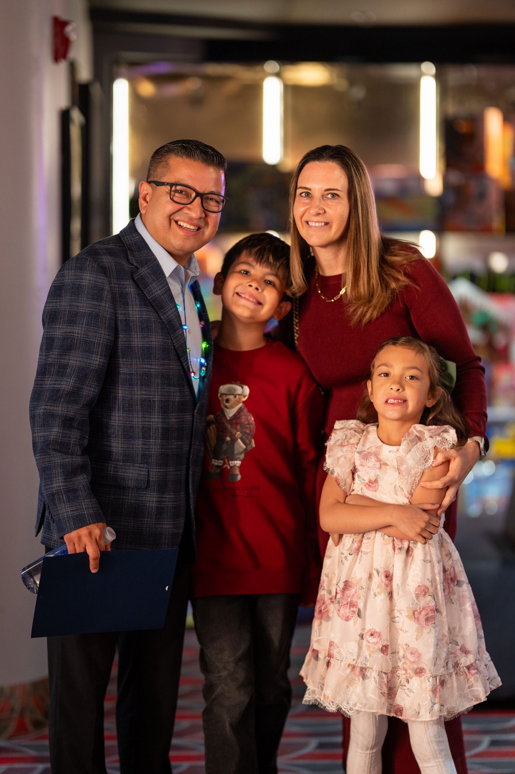 Jesse Armendarez nest to a young boy, girl and woman