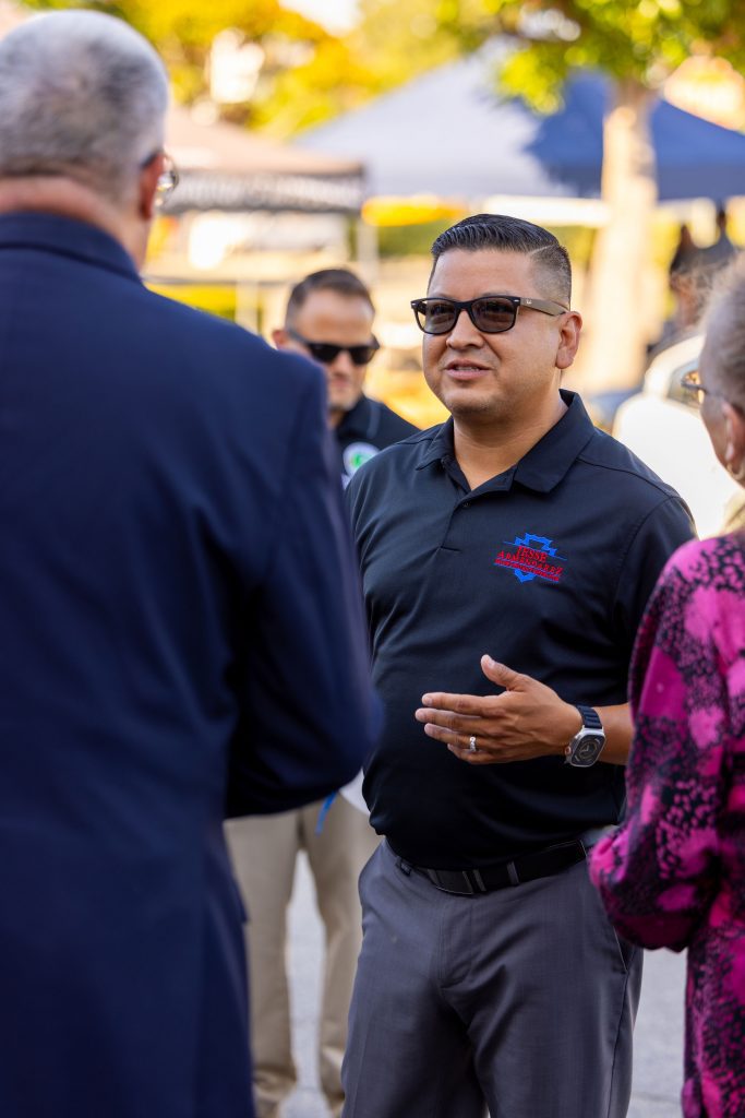 Jesse Armendarez speaking to people at an outdoor event