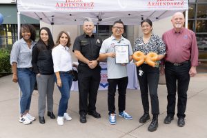 Jesse Armendarez holding a certificate of recognition for Panera Bread in Rancho Cucamonga outside with others.