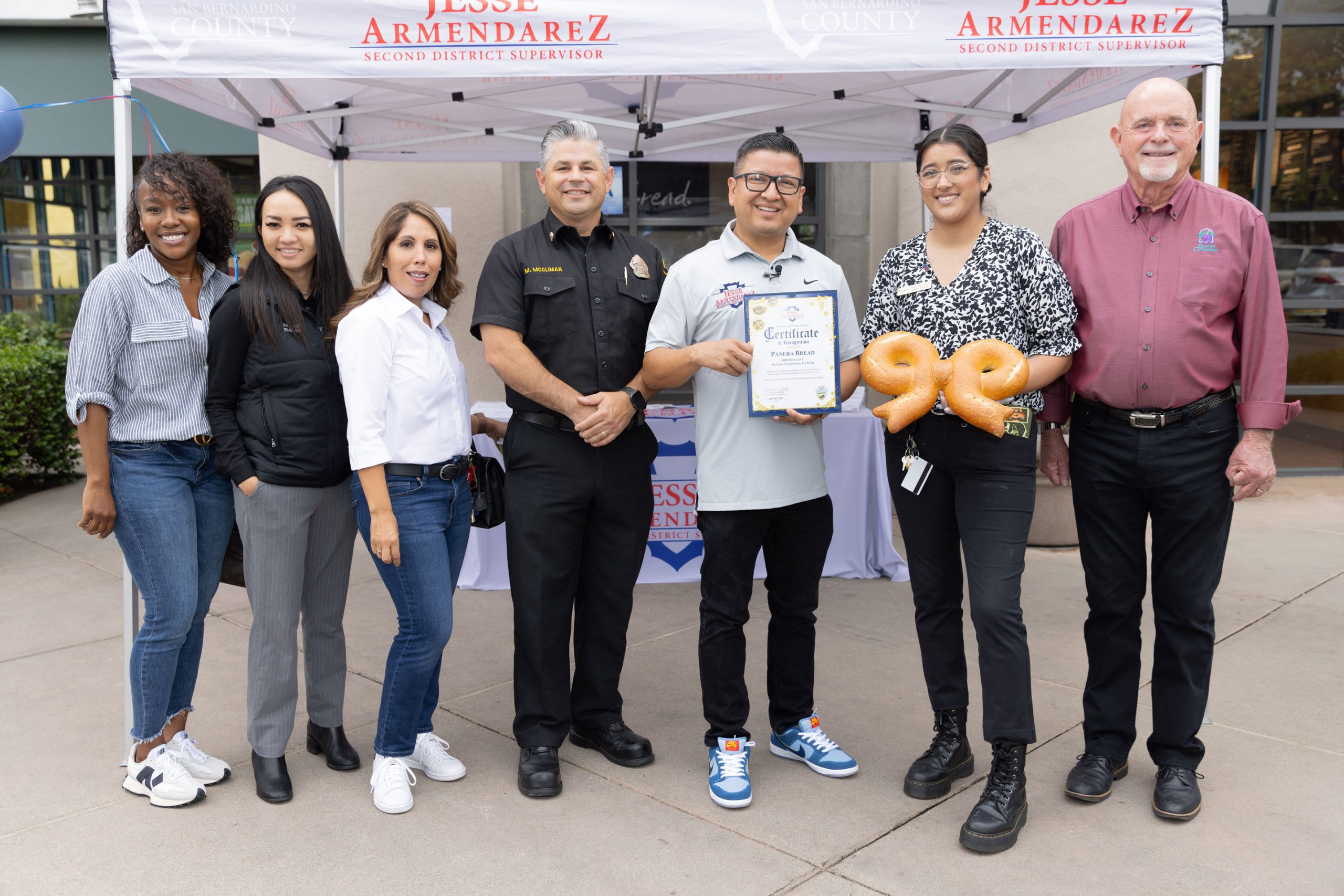 Jesse Armendarez holding a certificate of recognition for Panera Bread in Rancho Cucamonga outside with others.